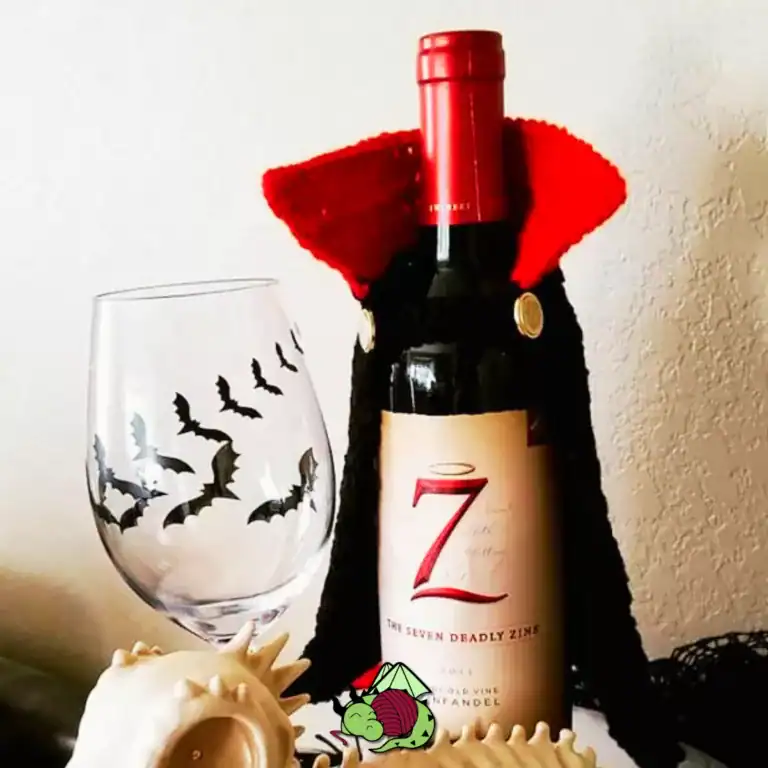 crochet vampire cape on a wine bottle