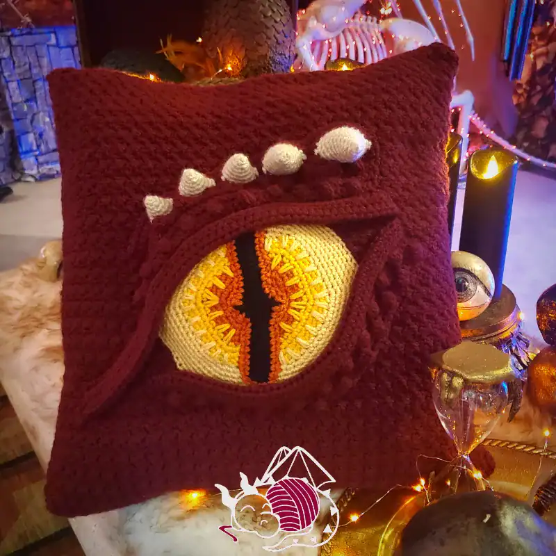Dragon Eye Pillow sitting on a Halloween themed table as a decoration