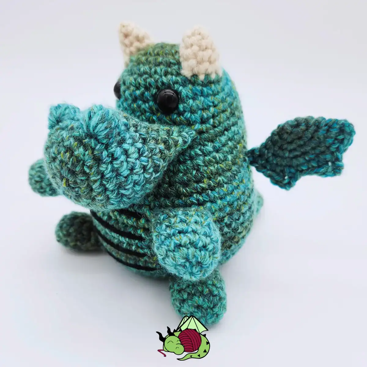 crocheted little blue round dragon plush, wings out